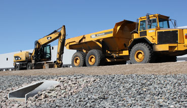Excavator and rock truck on site preparation project