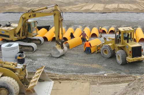 HM Lopes crew and equipment installing drainage system on jobsite